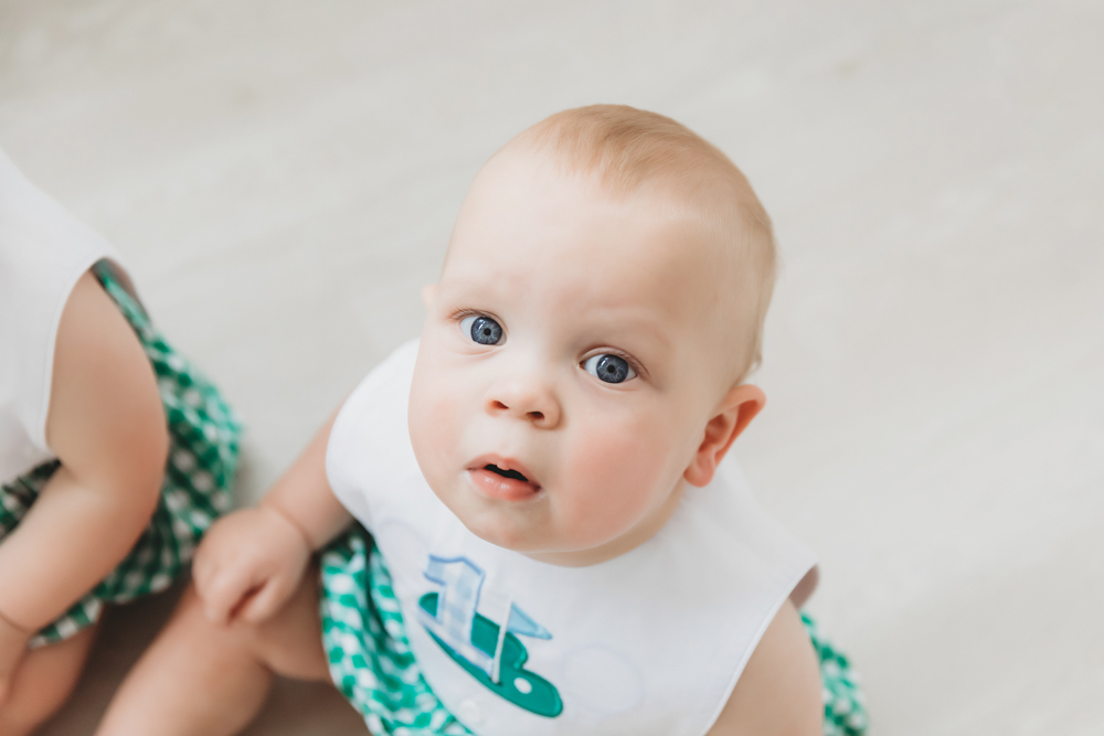 Macro portrait close-up of one twin's blue eyes while sitting on floor at Reflection Images by Tracy Rowell in Florence SC