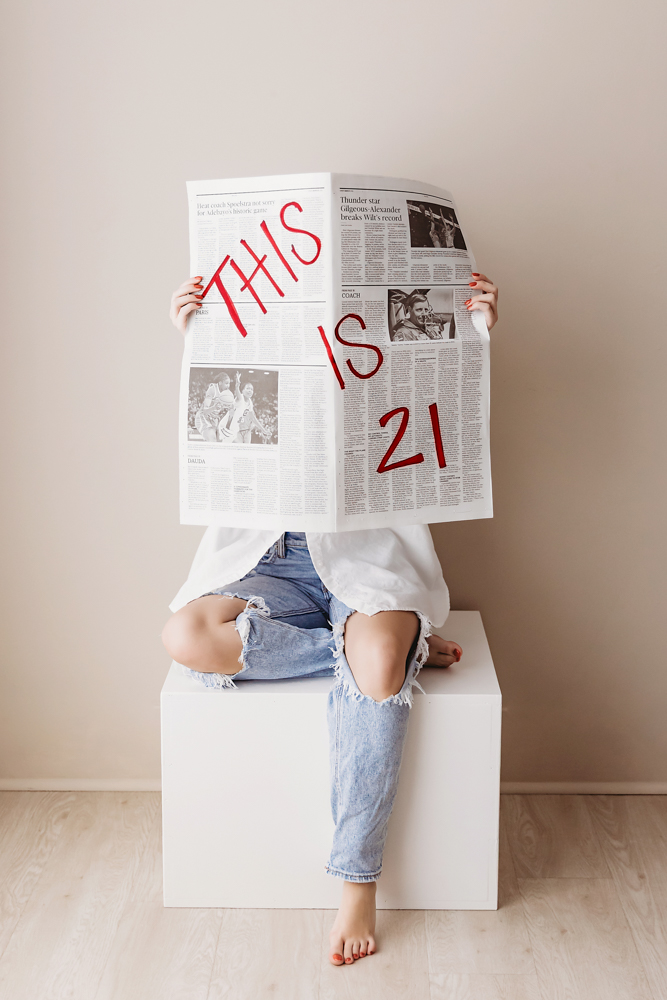 Child holding newspaper with 