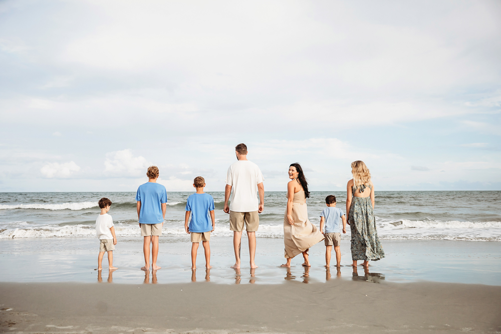 Culpepper family beach photography in Pawleys Island SC with boys in blue shirts and tan shorts, mom in a tan maxi dress.