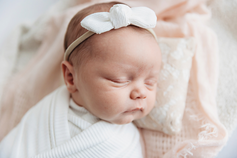 Newborn sleeping in ivory ribbed wrap, white knot headband, and blush blanket by Tracy Rowell, Florence SC photographer.