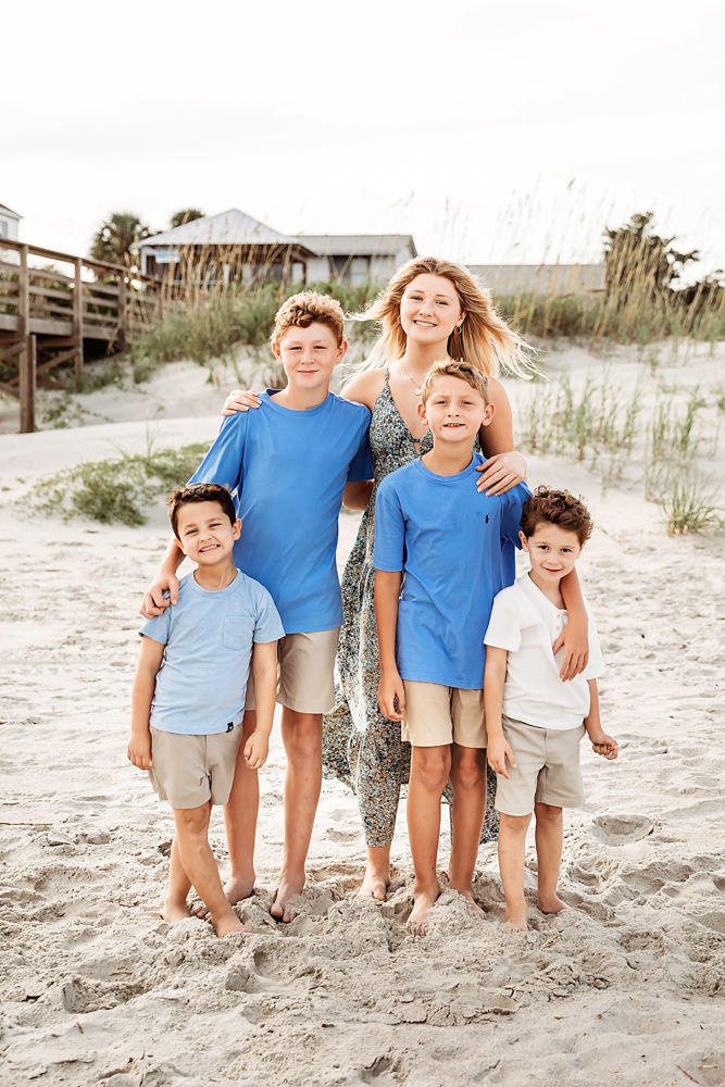 Culpepper family beach photography in Pawleys Island SC featuring sister in floral maxi dress and four boys in blue and taupe.