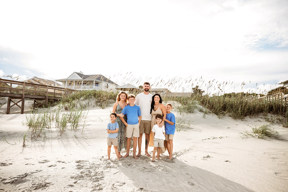 Culpepper family beach photos in Pawleys Island SC, wearing cerulean blue and taupe outfits on sandy dunes.