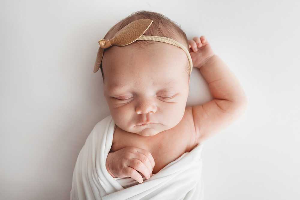 newborn natural pose simple white