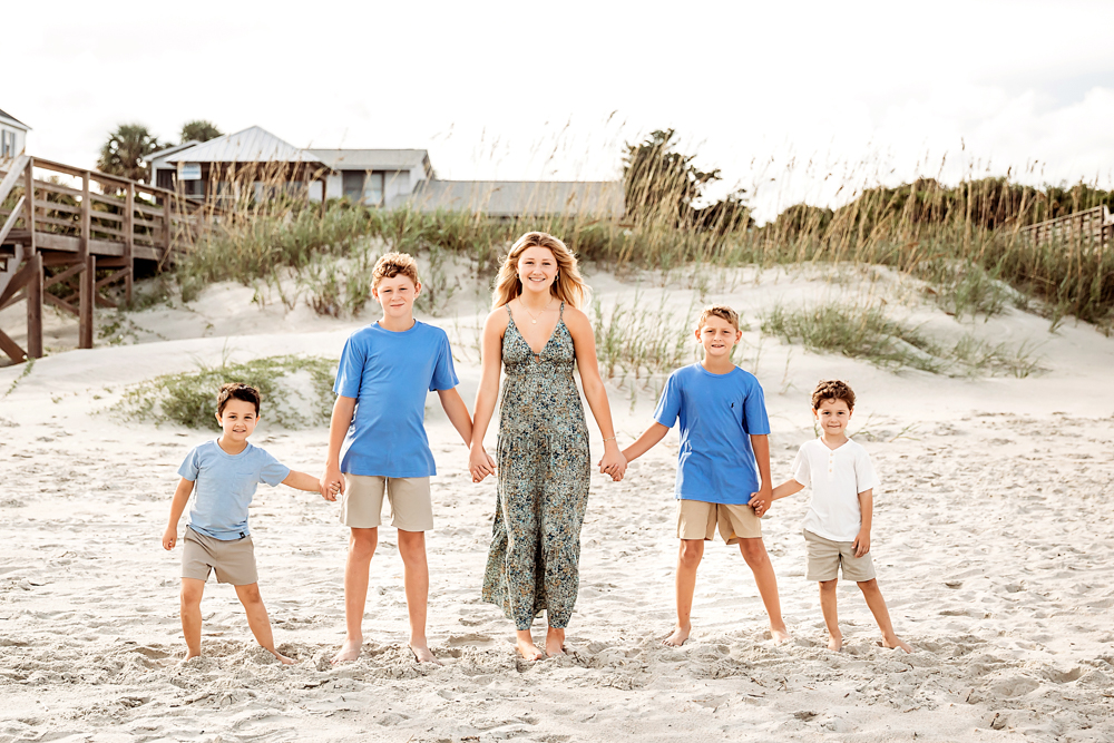 Culpepper siblings holding hands on Pawleys Island SC beach in a blue and taupe color scheme for family beach photography.
