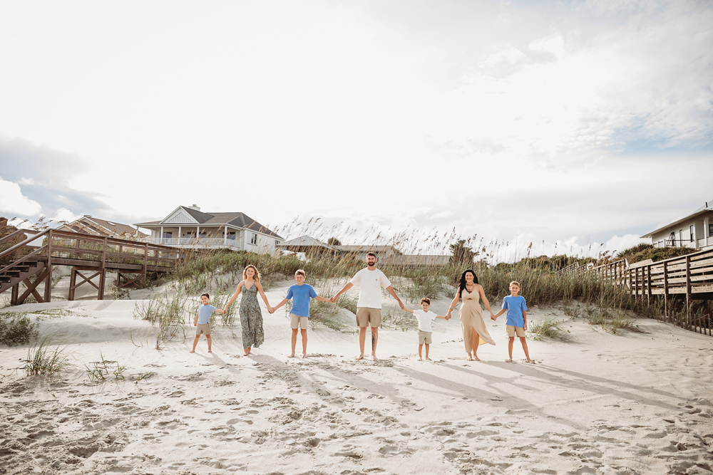 Culpepper family holding hands on Pawleys Island SC beach in a colorful lifestyle family session.